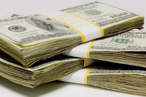 large pile of dollar bills made from three stacks of cash