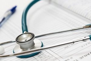 a medical record with a pen and a stethoscope on it